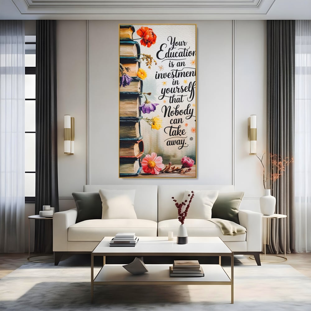 Tablou canvas cu tablou motivational cu teanc de carti si flori, in rama de aluminiu auriu, pe perete intr-un living